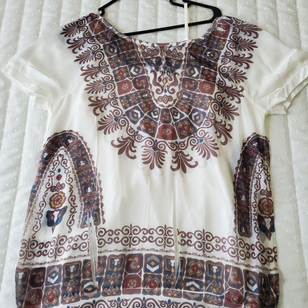 Two piece set. Sheer top with a cami underneath.